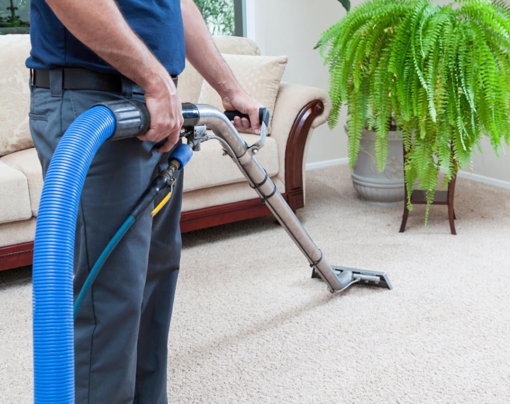 man cleaning living room carpets